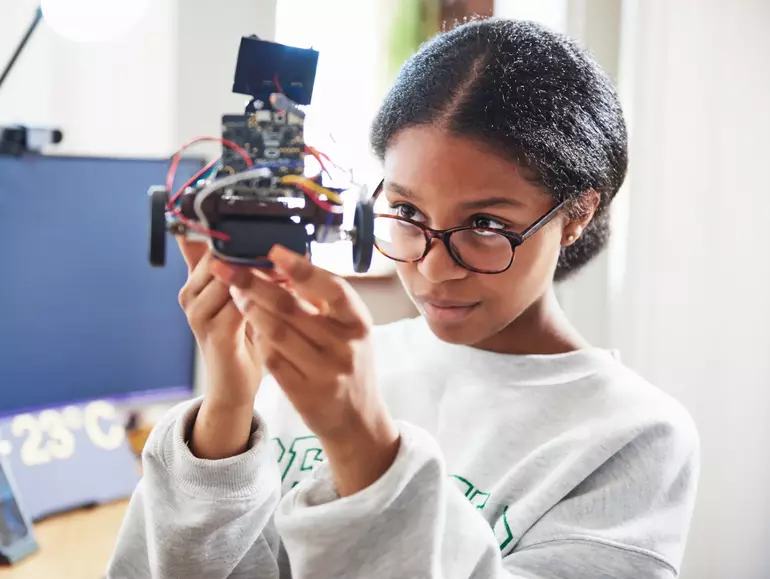 Teenage girl building robot Teenage girl building robot