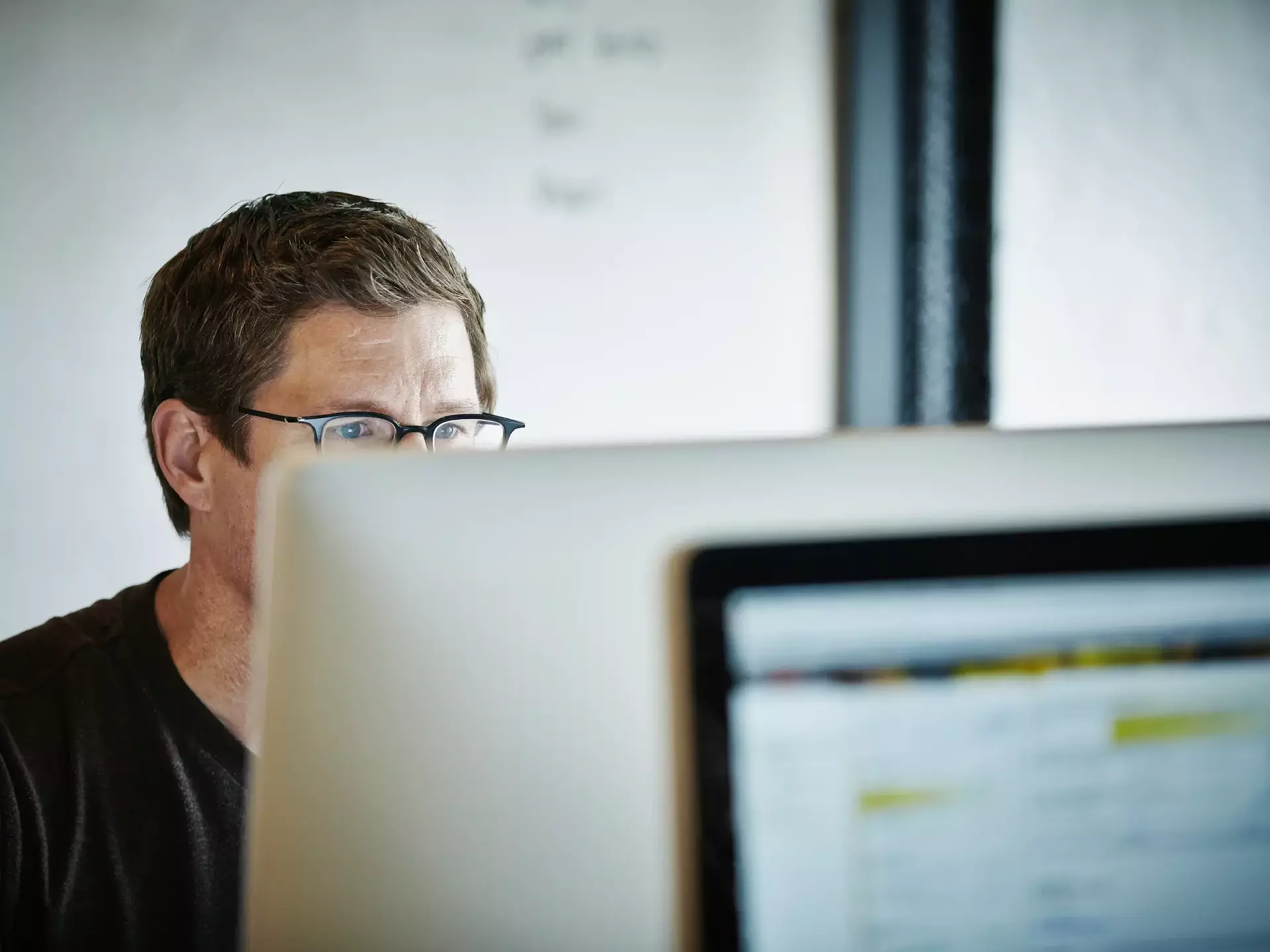 Businessman sitting at desk working on computer