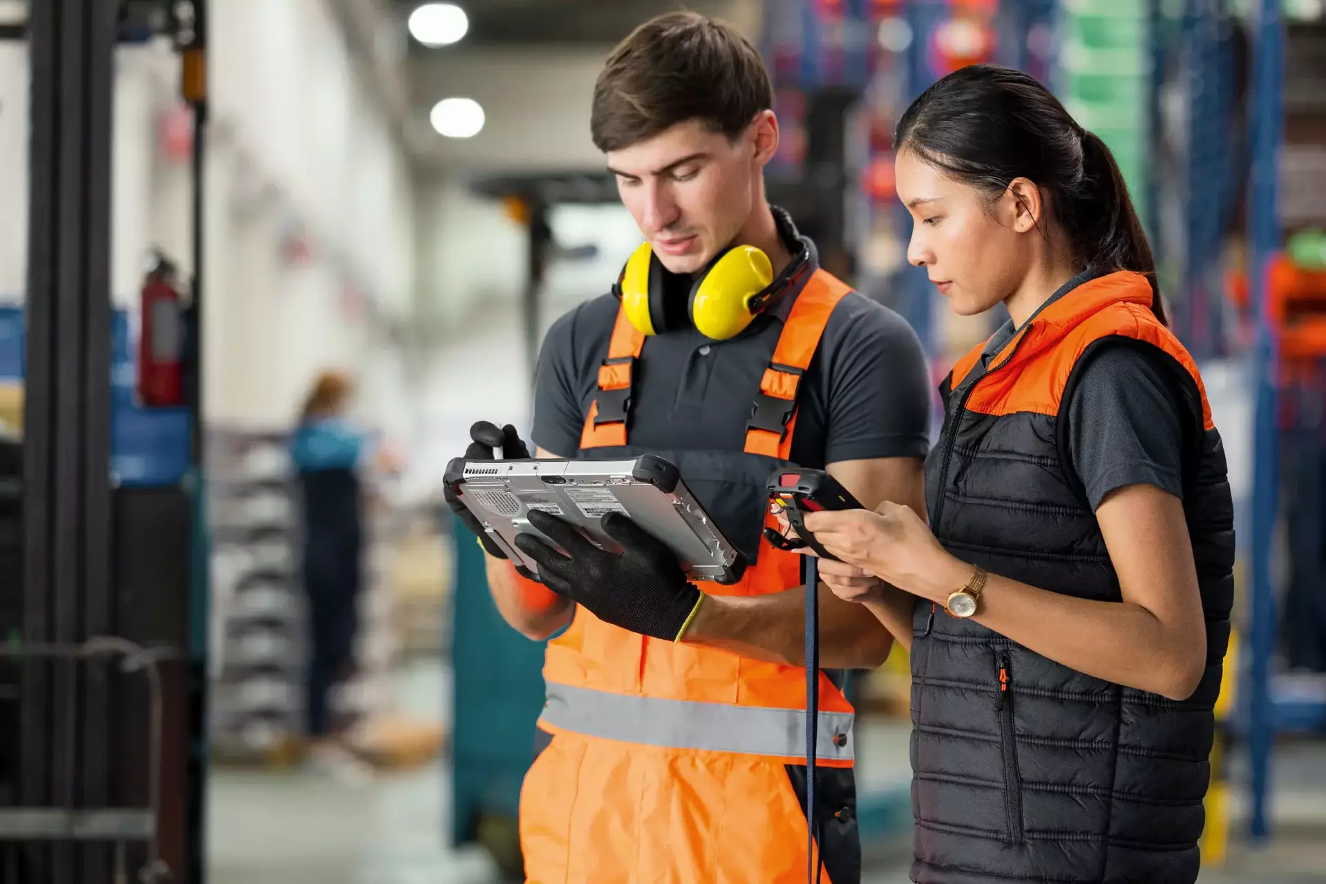Wireless solutions for inventory control femal chief and male warehouse technician having a discussion on data Wireless solutions for inventory control femal chief and male warehouse technician having a discussion on data