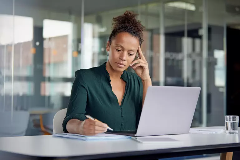 Portrait of pensive business woman working at desk