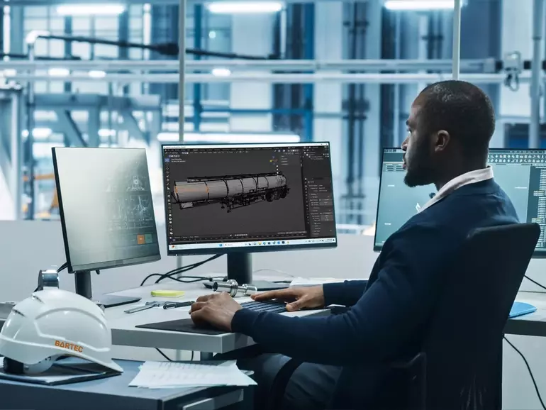 Man sitting at a desk behind a computer