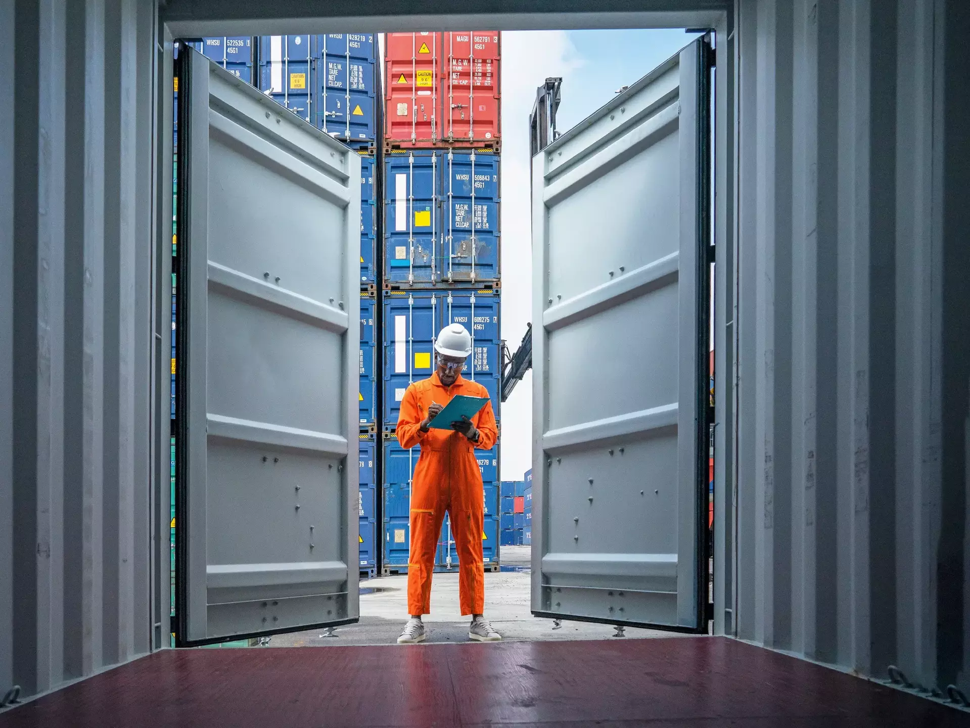 Foreman control loading containers box from cargo freight ship for import export Foreman control loading containers box from cargo freight ship for import export